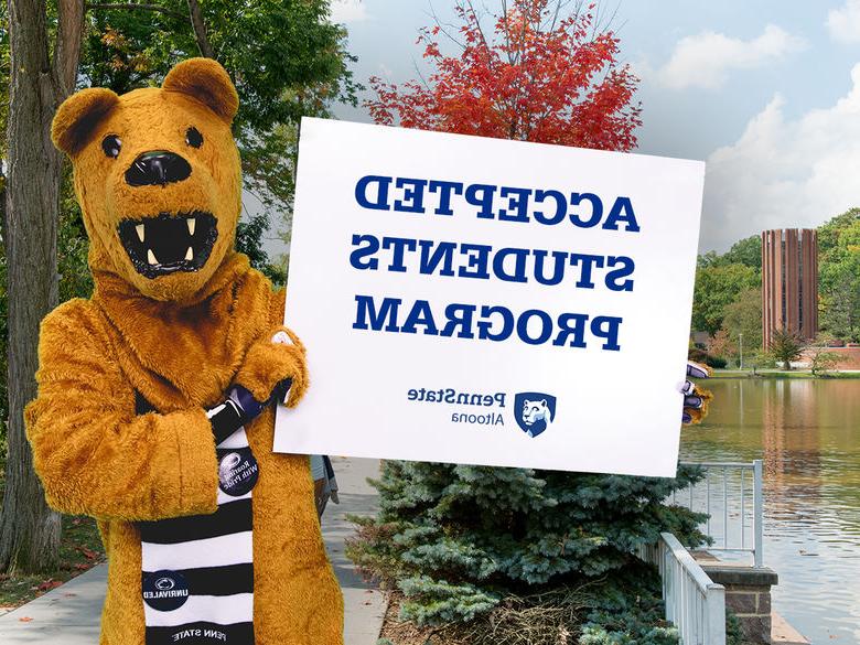 The Nittany Lion mascot holding a sign advertising Penn State Altoona's Accepted Students Program